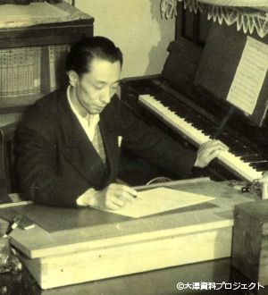 1950-Nishinomiya, Japan- Hisato composes at home.